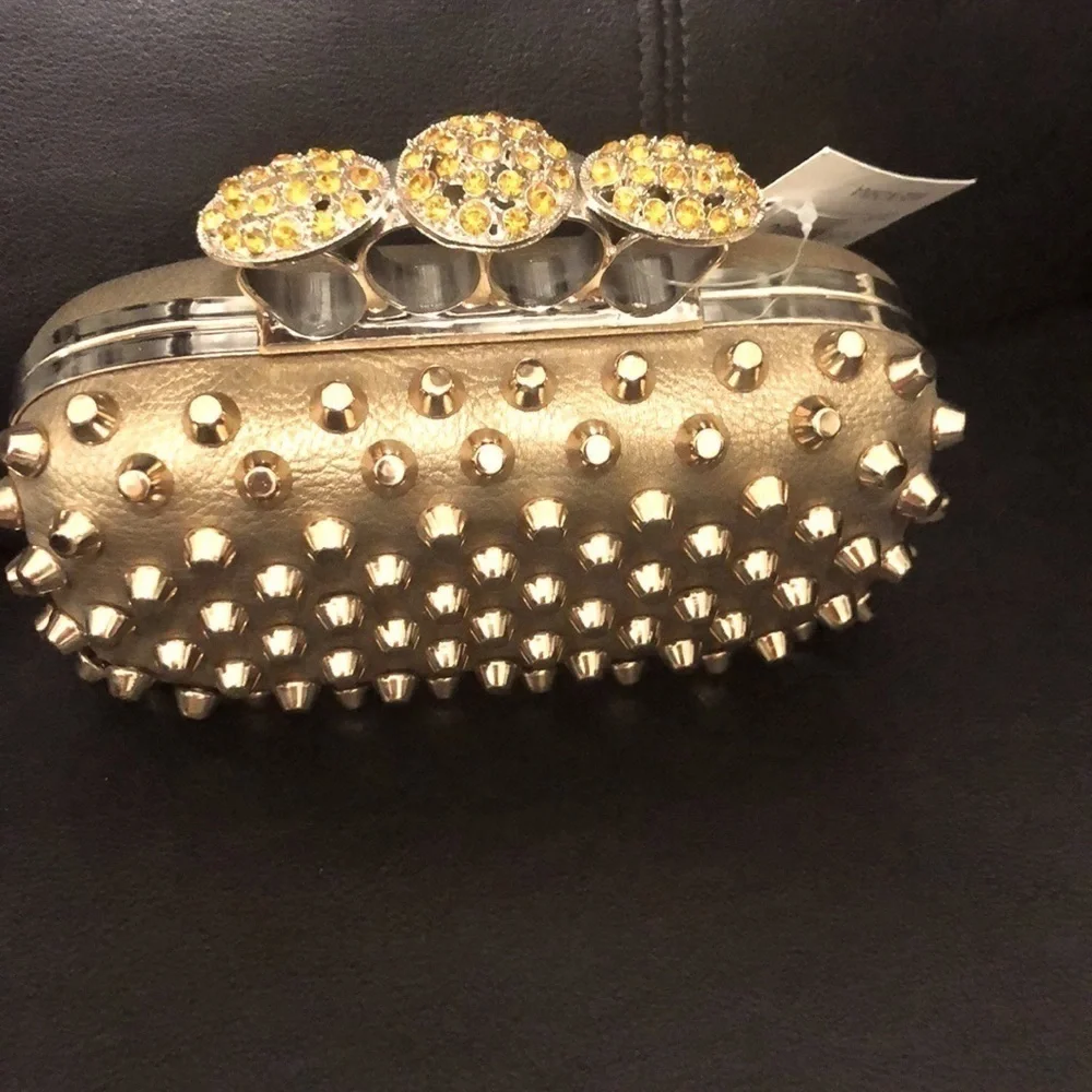 Skulls knuckles ring handles, rhinestone spikes studded clutch.